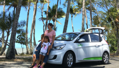family stands in front of jucy car