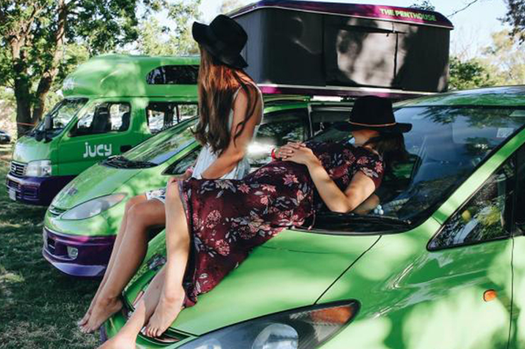 friends sleeping on jucy campervan at festival