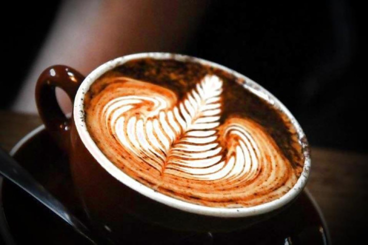 Close-up of coffee in cup with leaf latte art
