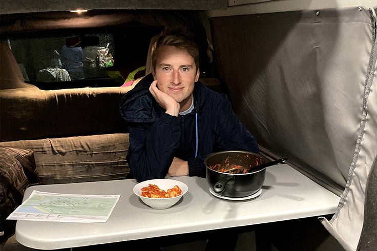 boy-inside-campervan-with-food-on-table