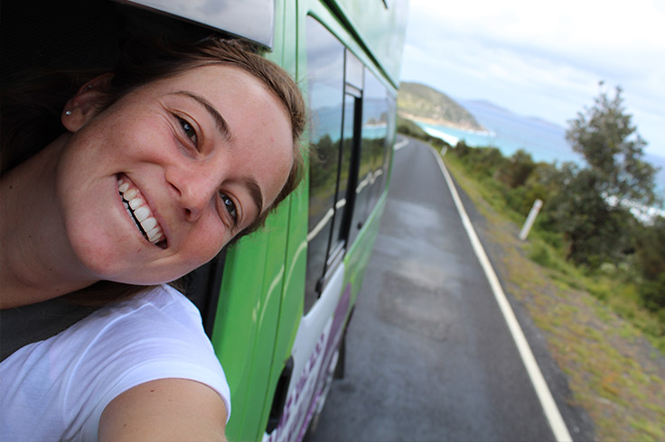 girl-travel-with-jucy-campervan-on-road