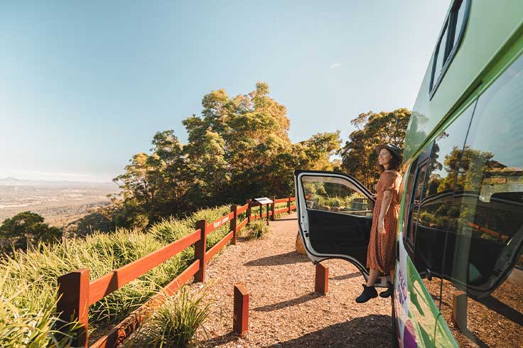 Women looking out at view from passenger door of JUCY Condo Campervan