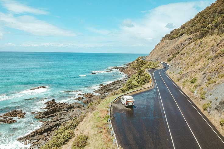 Drone shot above a JUCY Coaster Campervan at a Great Ocean Road lookout 