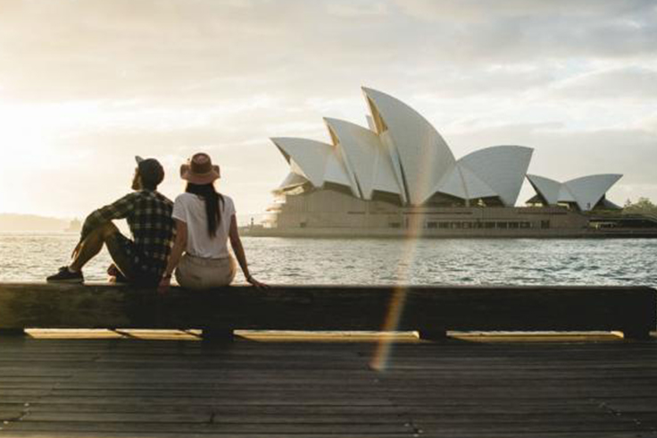 couple sit in front of opera house