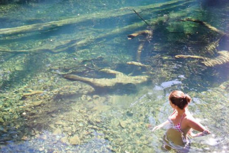 girl swims in pool in daintree rainforest