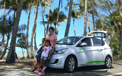 family stands in front of jucy car
