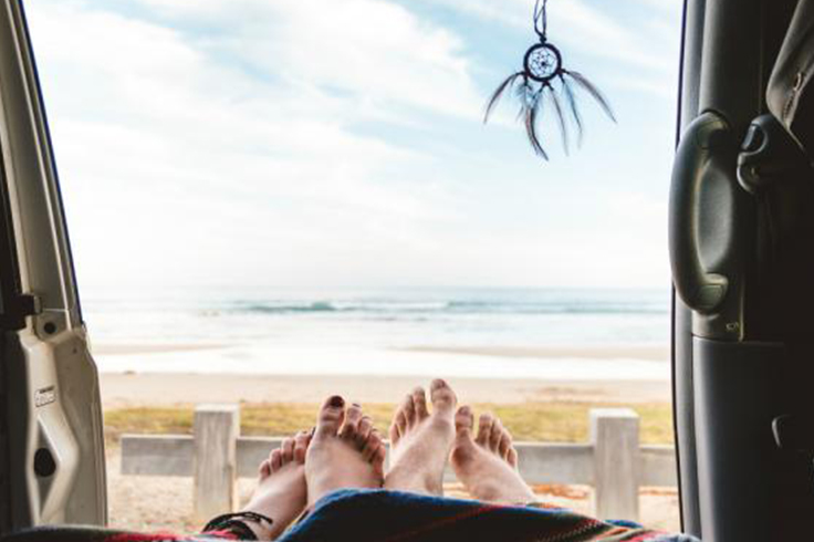 Waking up to a beach view in a campervan