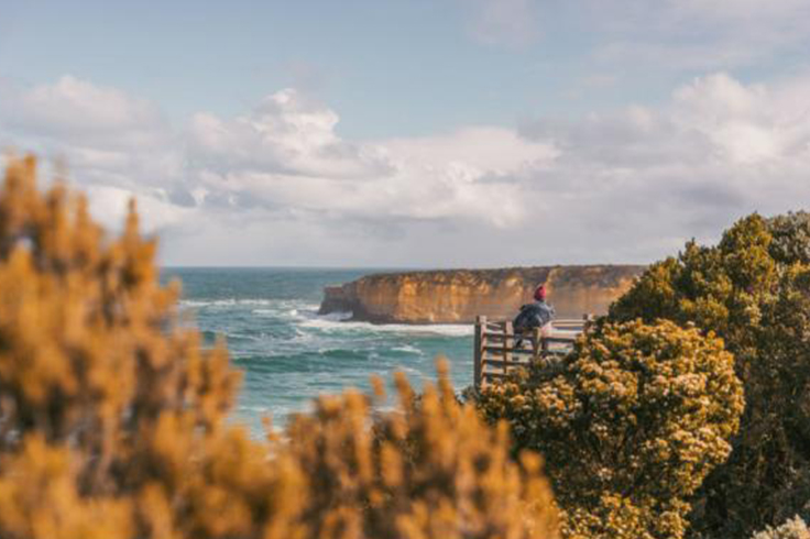 girl looks out at beach on great ocean road