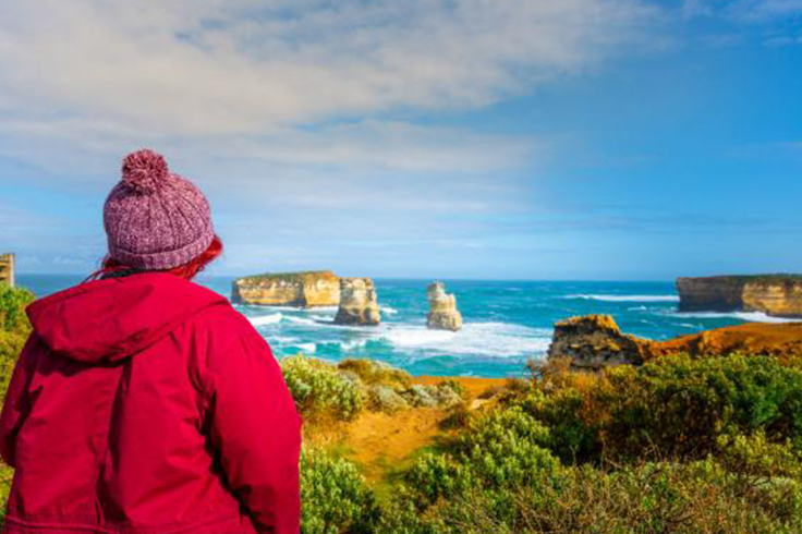 girl looking at view of twelve apostles on great ocean road