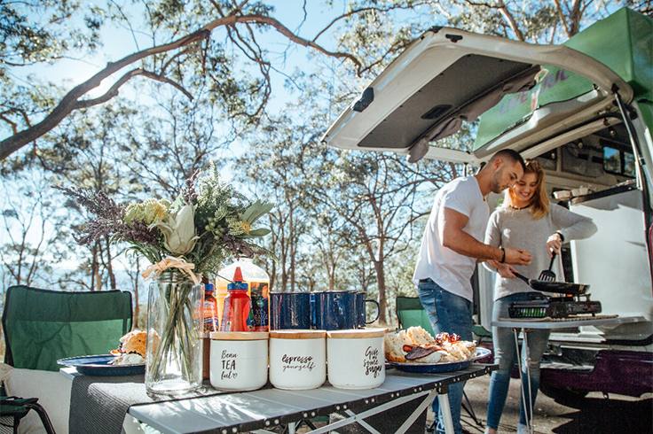 couple-cooking-from-back-of-campervan