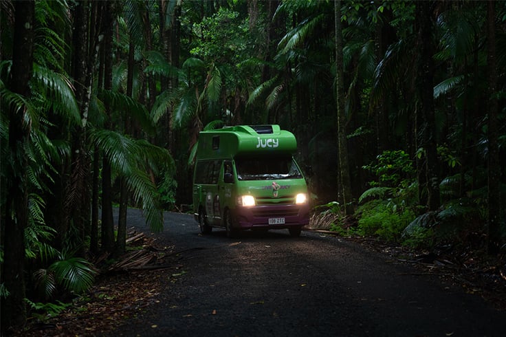campervan-driving-through-forest