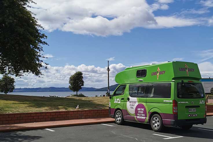JUCY campervan parked by Rotorua Lake