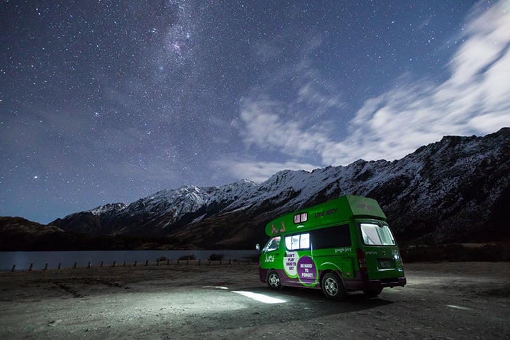 JUCY Campervan lit up inside at night