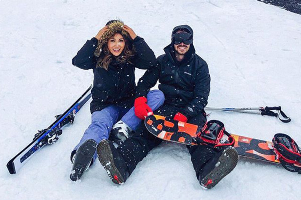 Couple sitting down in ski gear on South Island ski field