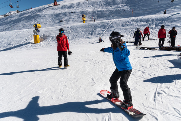 Person in blue jacket snowboarding