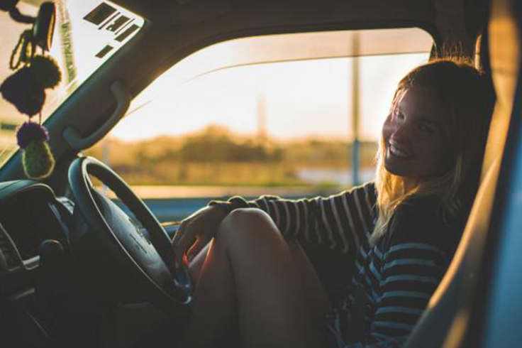 Girl in driving seat of JUCY camper