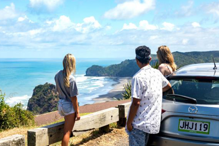 Three friends admiring beach view