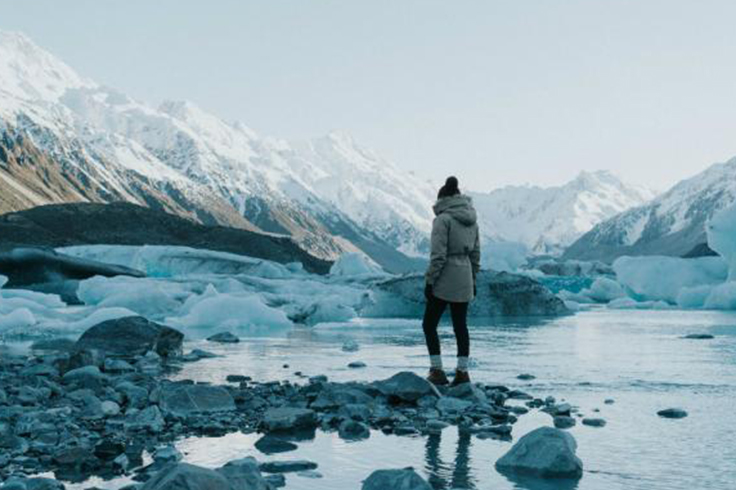 Girl standing in rocky rocky mountain stream