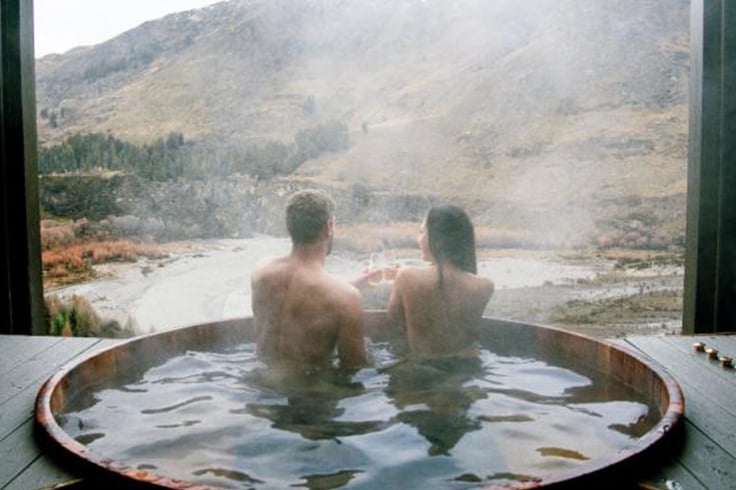 Couple relaxing in an outside spa bath