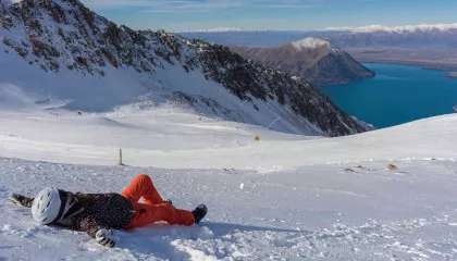 Skier lying down in South Island ski field