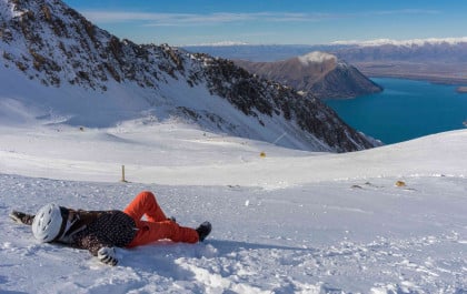 Skier lying down in South Island ski field