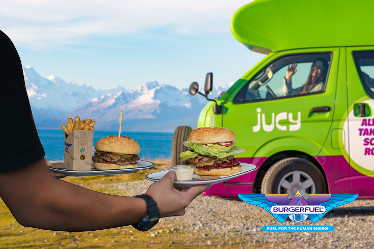 Man carrying BurgerFuel to girl in JUCY campervan