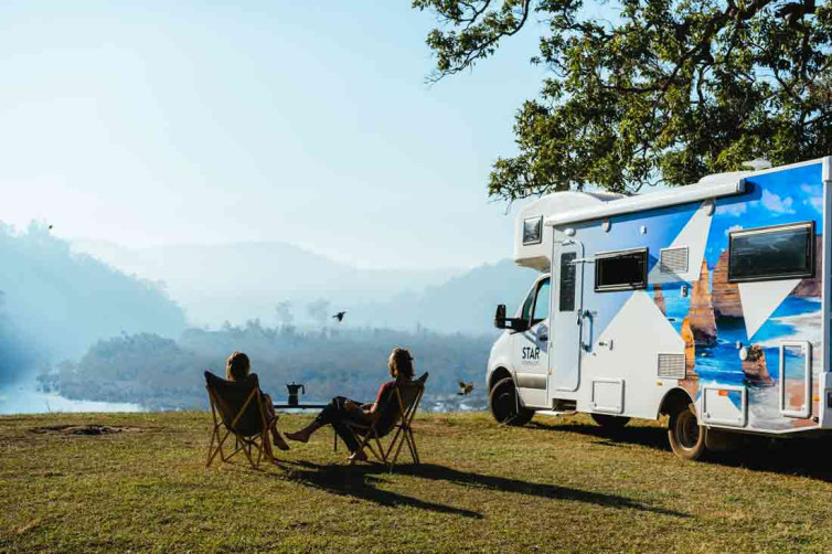 Couple sitting out Star RV motorhome Australia